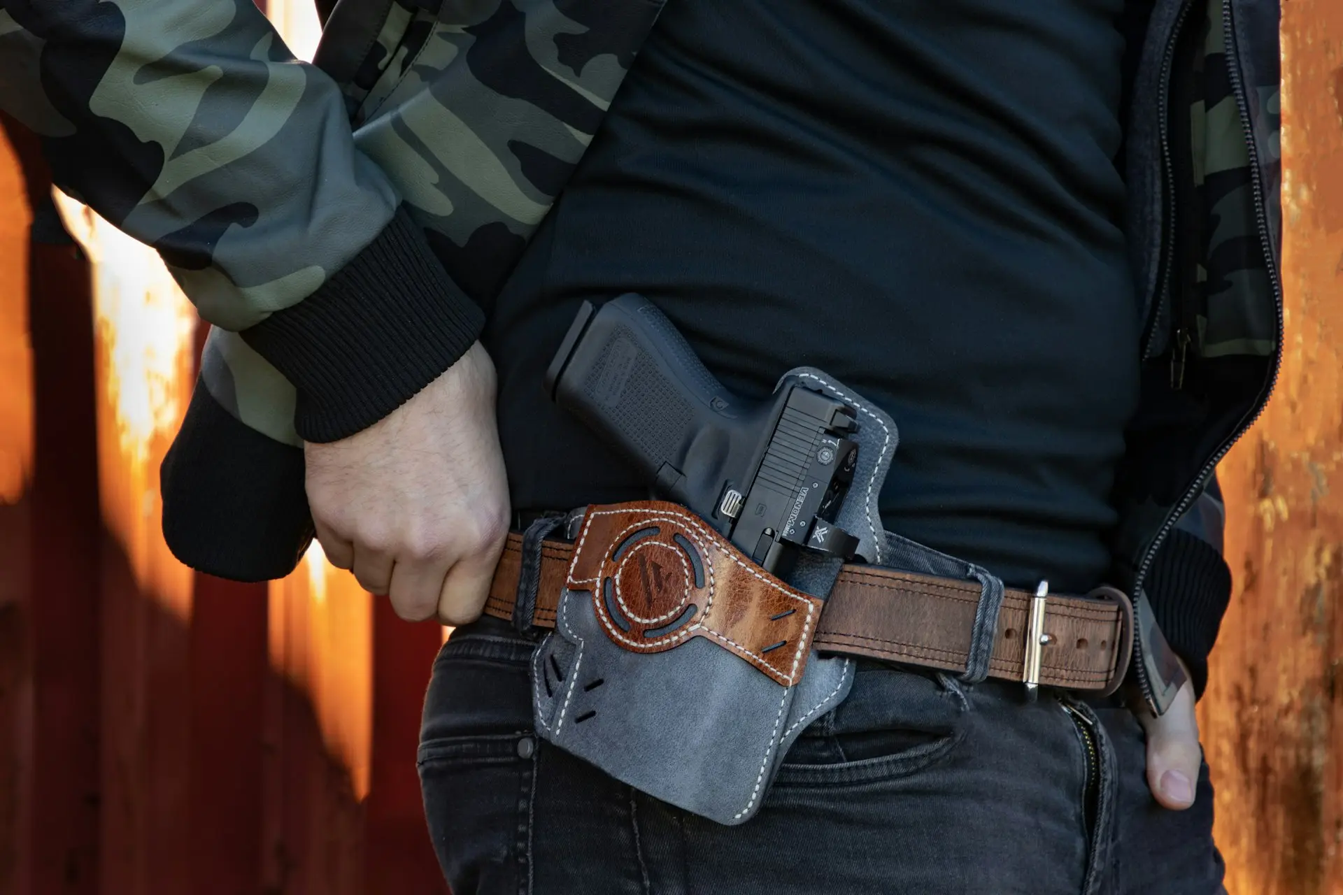 a man with a firearm in a holster on his hip